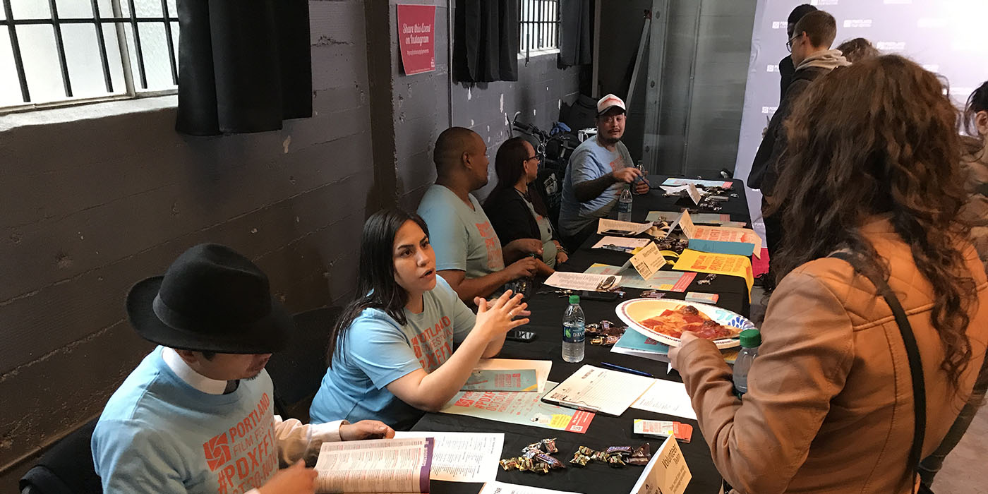 Portland Film Festival volunteer coordinator welcoming an attendee